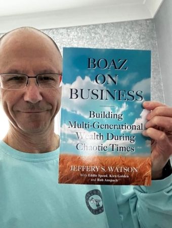 Male reader showing his copy of Boaz on Business book